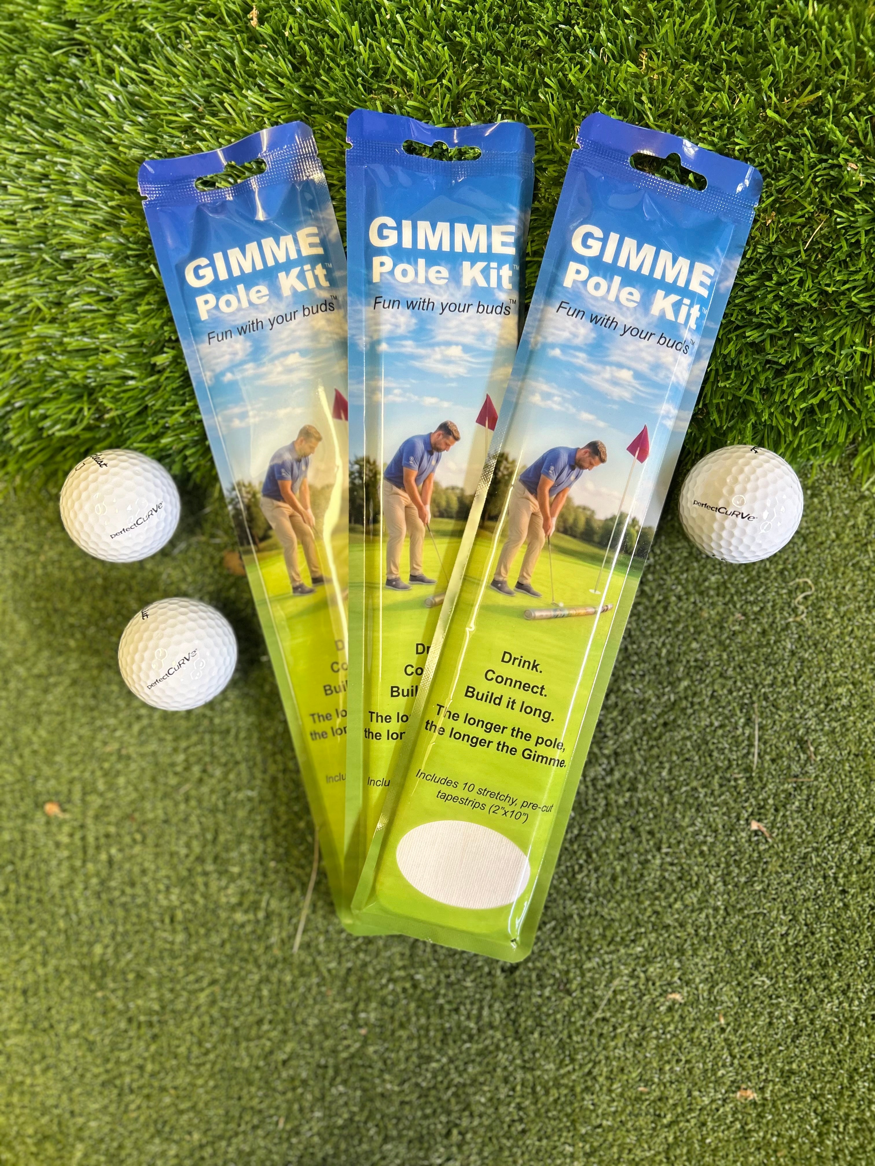 Three 'Gimme Pole Kit' packages on a grass background with golf balls.